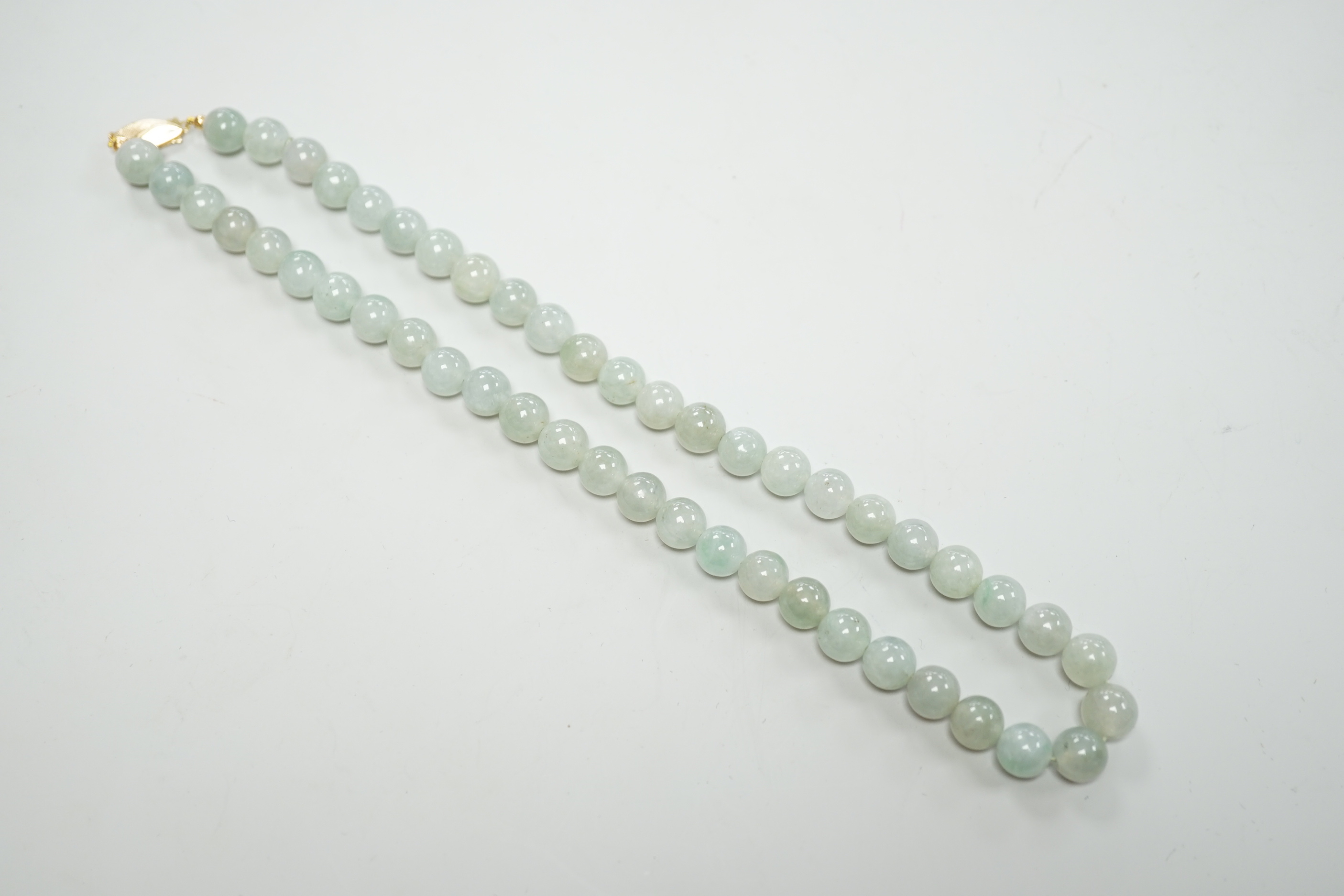 A single strand jadeite bead necklace, with 18k clasp, 43cm, gross weight 58.7 grams, with accompanying Gem & Pearl Laboratory report dated 18/03/2019, stating the jade to have no evidence of treatment.